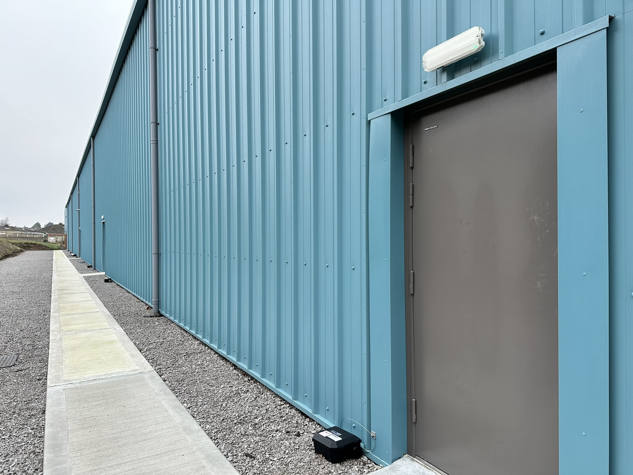 Blue industrial building with metal cladding