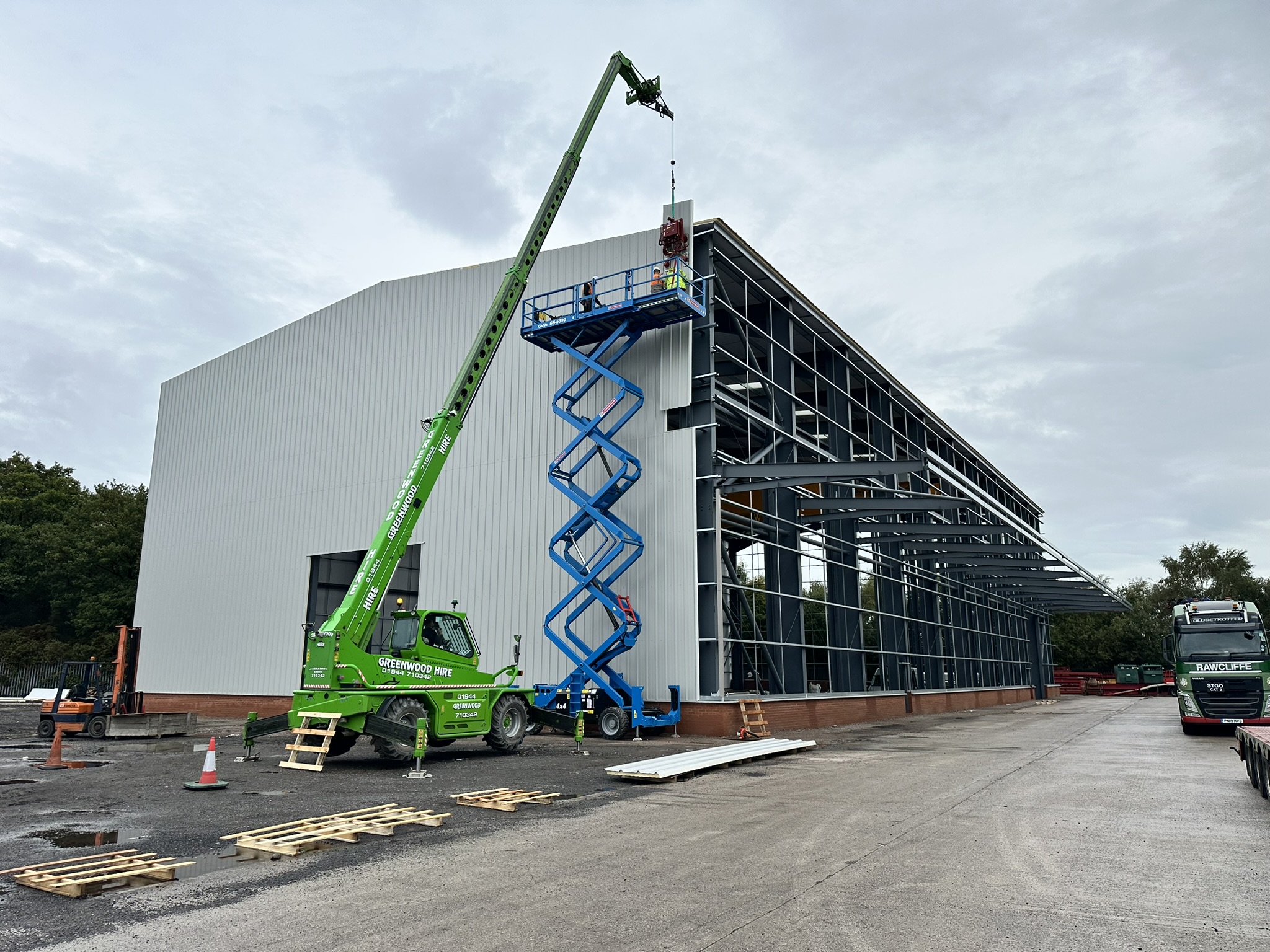 Cladding installation with crane and scissor lift